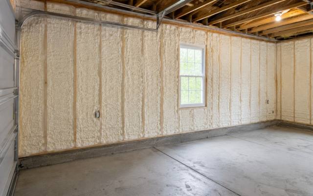 Garage walls filled with spray foam between the studs