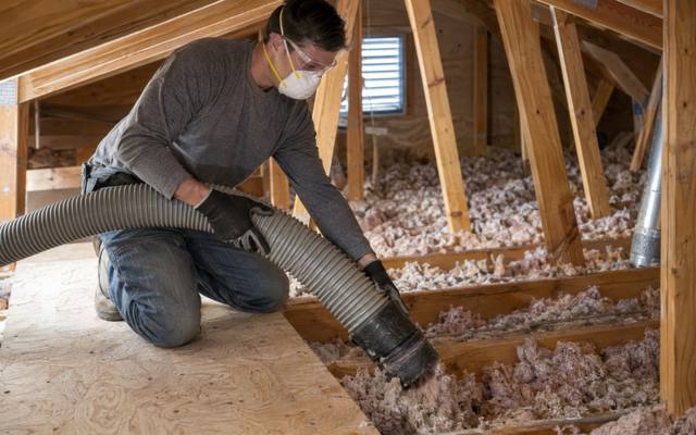Old attic insulation being vacuumed out